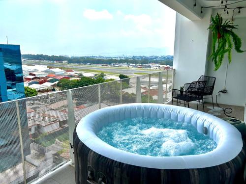 a large bath tub on a balcony with a view at Bertiz Cozy Jacuzzi in Guatemala