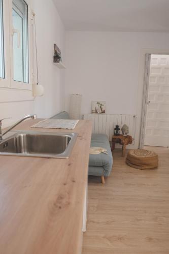 a kitchen with a sink and a wooden counter top at Casa con encanto in Corbera de Llobregat