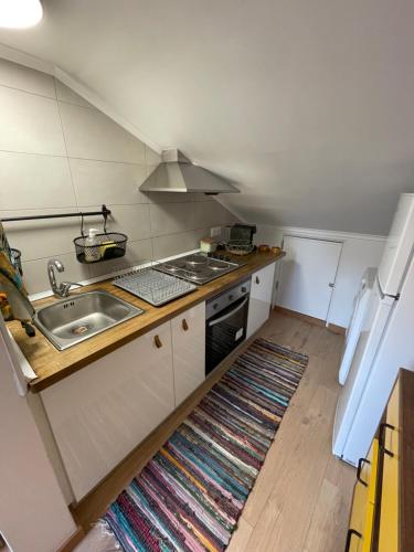 a kitchen with a sink and a stove at Lisbon Soul Surf Camp in Cascais