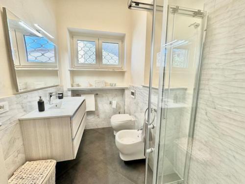 a bathroom with a shower and a toilet and a sink at Villa Matteotti Garden Lux 200mt by the sea in Forte dei Marmi