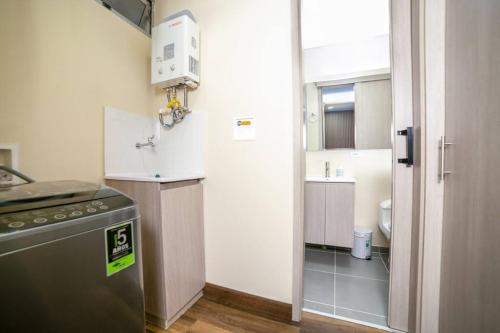 a small kitchen with a refrigerator and a sink at Apartment in Medellin in Sabaneta