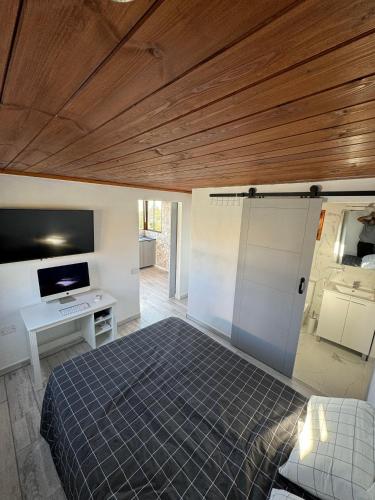 a bedroom with a bed and a wooden ceiling at Atico Valentina in El Paso