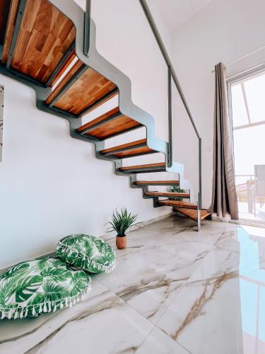 a staircase in a living room with a potted plant at LOUTRA VILLAS in Agia Paraskevi