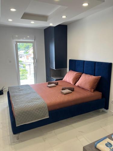a bedroom with a large bed with two towels on it at Vip apartmani in Tivat