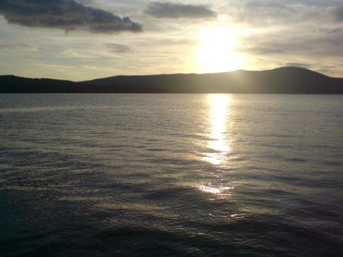 a sunset over a large body of water at Vip apartmani in Tivat