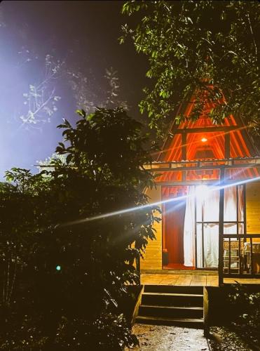 a gazebo with a lit up door at night at Finca La Rivera in San Agustín