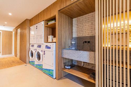 uma lavandaria com máquina de lavar e secar roupa em 617 - Rentaqui Studio Comfort Butantã em São Paulo