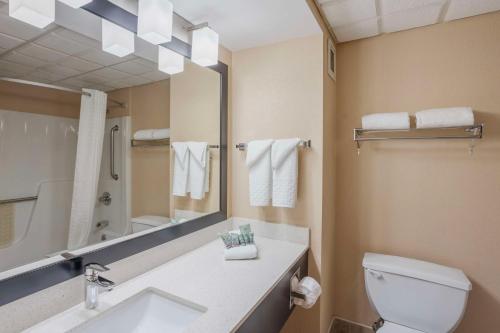 a bathroom with a sink and a toilet and a mirror at Best Western Inn at Blakeslee-Pocono in Blakeslee