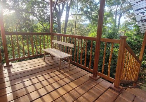 a wooden porch with a bench on a deck at Finca La Rivera in San Agustín