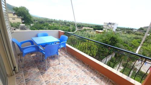 a balcony with a table and chairs on it at Friends House - Borsh Hotel in Borsh