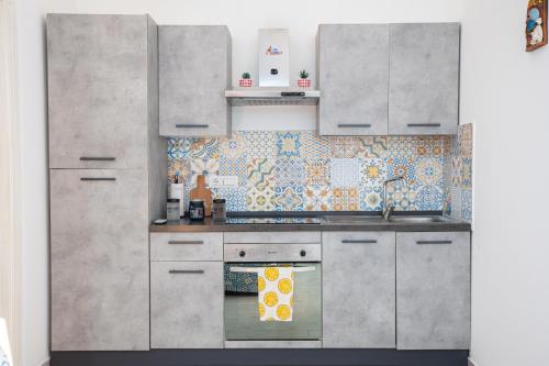 a kitchen with stainless steel cabinets and a stove at Napoli Centro Casa Vacanza in Naples