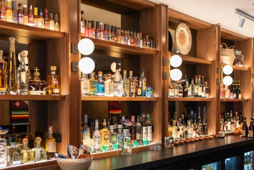 a bar filled with lots of bottles of alcohol at TRYP Adelaide by Wyndham in Adelaide