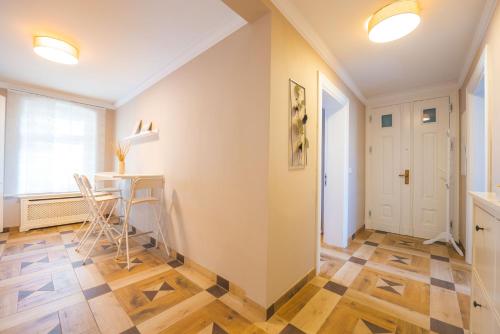a hallway with a table and chairs in a room at Lux Central Apartment in Berlin