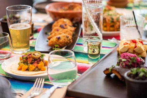 a table with plates of food and glasses of beer at TRYP Adelaide by Wyndham in Adelaide