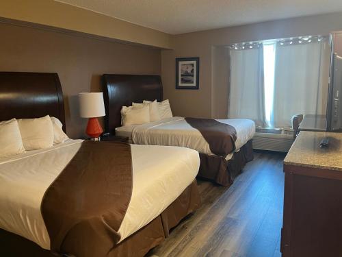 Ένα ή περισσότερα κρεβάτια σε δωμάτιο στο Americas Best Value Inn Kalispell