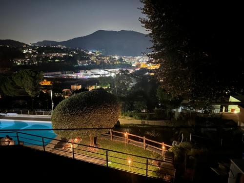 a view of a pool at night with a city at Veralto - Modern Suite with Como Lake view in Vacallo