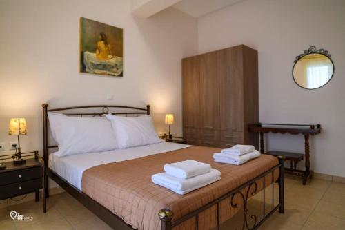 a bedroom with a bed with two towels on it at Luxury Villa King George in Nea Makri in Nea Makri