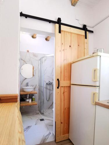 a kitchen with a refrigerator and a sink at Sotiria Apartments in Kókkinon Nerón