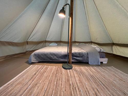 a bedroom with a bed in a tent at Deleni Retreat - Glamping in Buzău