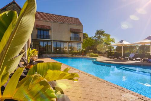 a swimming pool in front of a building at Club Wyndham Dunsborough, Trademark Collection by Wyndham in Dunsborough