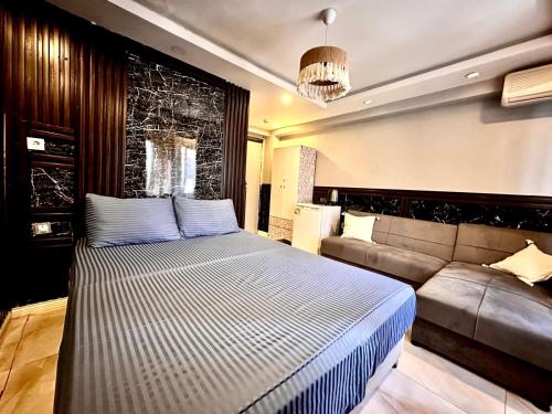 a bedroom with a bed and a couch at Golden Prince Hotel Taksim in Istanbul