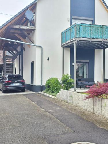 a car parked next to a building with a balcony at Design I Gewölbe I sanierter Pferdestall I EuropaPark I Boxspring I Nespresso I Terrasse I Parkplatz in Kippenheim