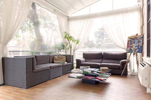 a living room with two couches and a table at Villa Pirandello in Rome