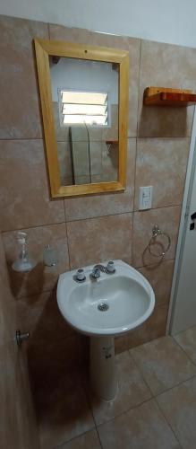 a bathroom with a white sink and a mirror at Schönes Loft in Villa General Belgrano