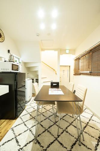 a kitchen and dining room with a table and chairs at 18, Oji B, Detached house for rent, 王子B in Tokyo