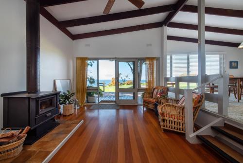 a living room with a wood stove and a living room at Pebble Views by Property Mums in Flinders