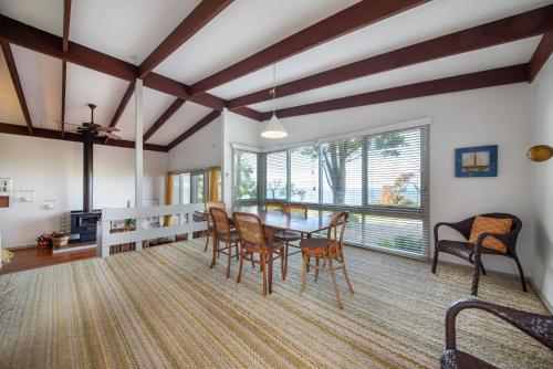 a dining room with a table and chairs at Pebble Views by Property Mums in Flinders