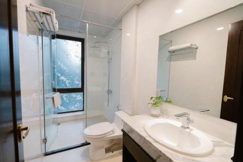 a bathroom with a toilet and a sink and a shower at A&D Luxury Hotel in Hanoi