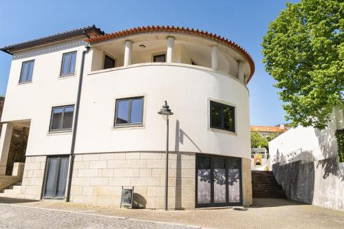 a white house with a round turret at Casa de Arouca - Arouca Suítes in Arouca