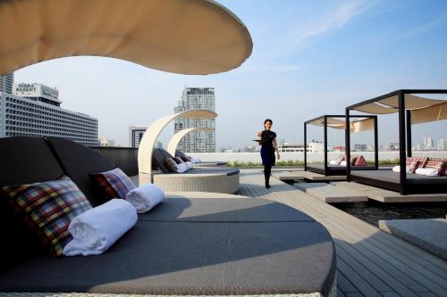 a woman standing on the roof of a building at Centara Watergate Pavilion Hotel Bangkok in Bangkok