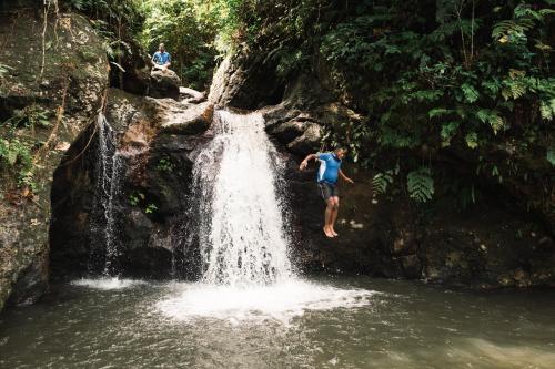 a man standing in front of a waterfall at PAPAGENO RESORT & DIVE in Kadavu