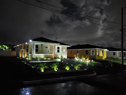 a house at night with lights in the yard at The Surada Bay 2 bedrooms in Old Harbour
