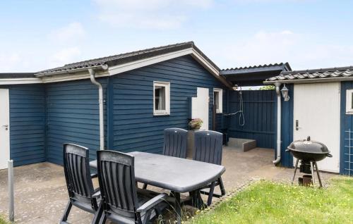 a table and chairs in front of a blue house at Stunning Home In Esbjerg V With Wifi in Esbjerg