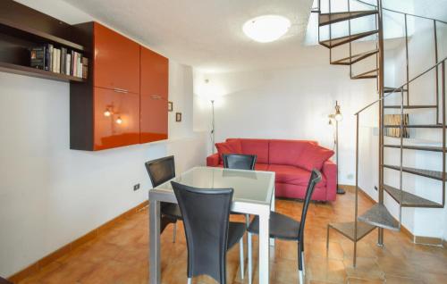 a living room with a table and a red couch at Gorgeous Home In Serrone With Wifi in Serrone