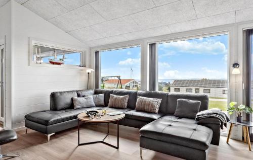a living room with a leather couch and a table at Cozy Home In Faaborg With Wifi in Fåborg