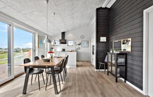 a kitchen and dining room with a table and chairs at Cozy Home In Faaborg With Wifi in Fåborg