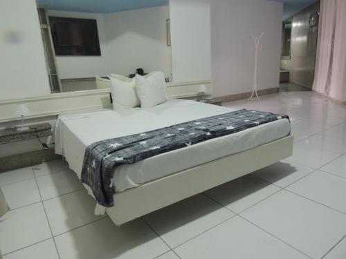 Postel nebo postele na pokoji v ubytování Lourdes Prime Hotel - Fácil Acesso Savassi
