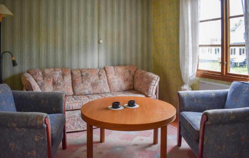 a living room with a couch and two chairs and a table at Gorgeous Home In Jämjö With Kitchen in JÃ¤mjÃ¶