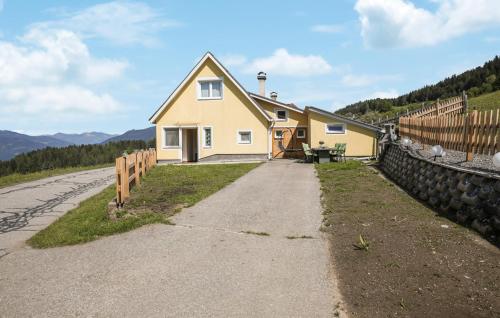 a yellow house on the side of a road at Ferienhaus In Mariahof in Mariahof