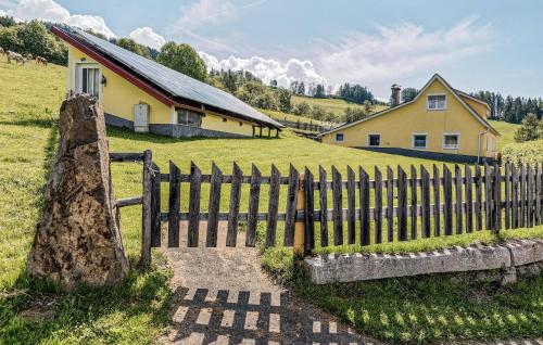 a wooden fence in front of a house at Ferienhaus In Mariahof in Mariahof