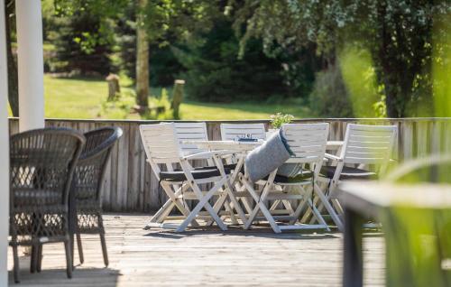a table and chairs sitting on a deck with at Pet Friendly Home In Farsø With Wifi in Farsø