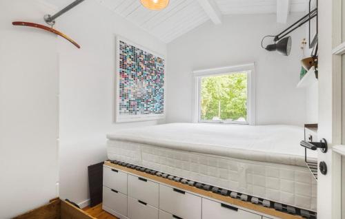 a bed in a room with a window at Lovely Home In Strøby With Wifi in Strøby