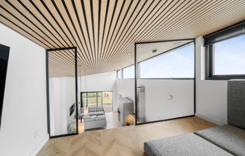 a living room with a couch and a large window at Lovely Home In Kerteminde With Wifi in Kerteminde
