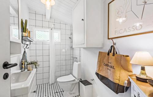 a small bathroom with a toilet and a sink at Lovely Home In Strøby With Wifi in Strøby