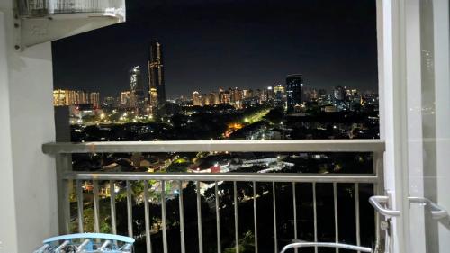 a view of a city at night from a balcony at Studio Apartment JiExpo Kemayoran View -Min Stay 3 nights- in Jakarta