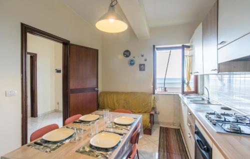 a kitchen with a table with chairs and a sink at 2 Bedroom Awesome Apartment In Messina in Briga Marina